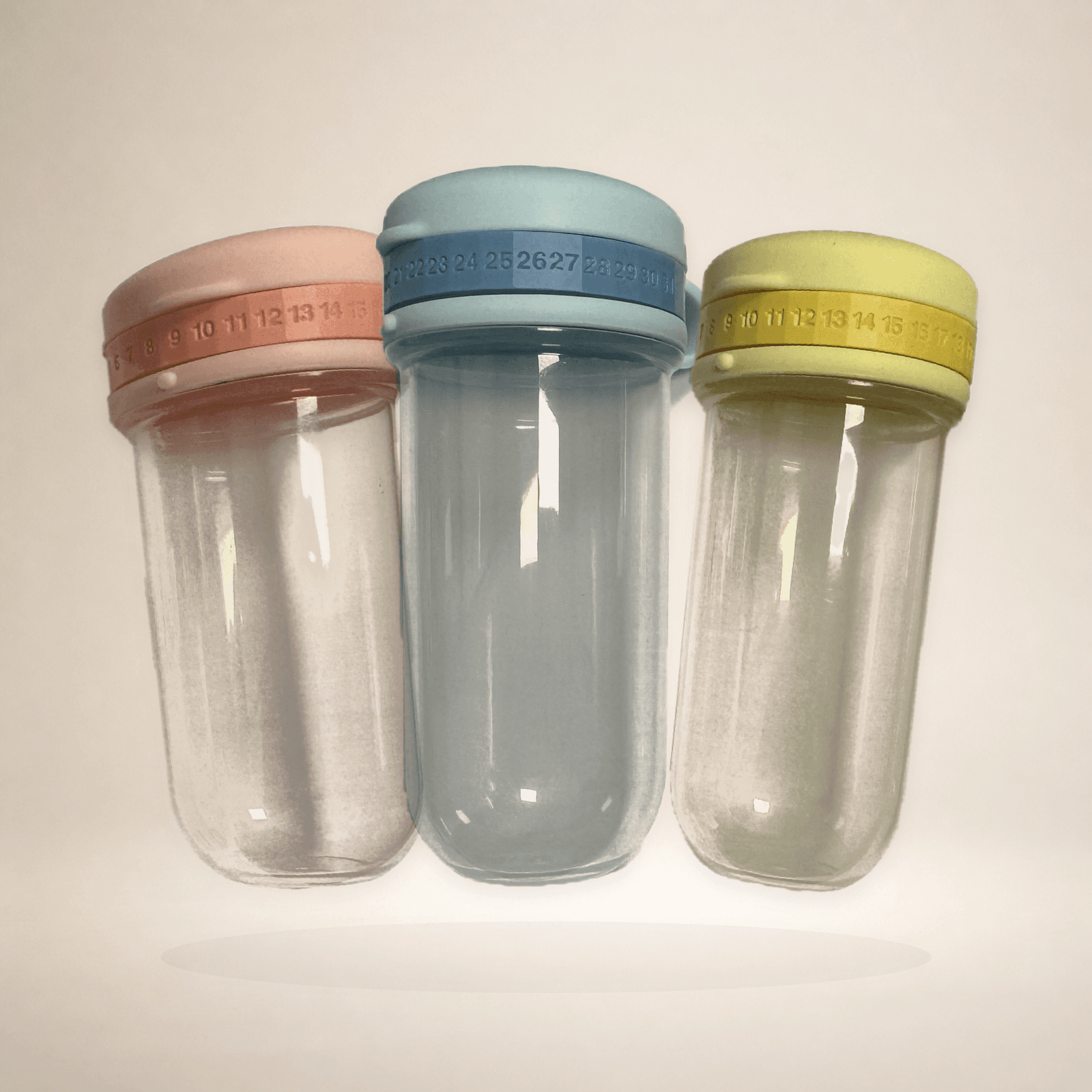Pink, blue and yellow formula portioning containers from the three-piece travel organisation set